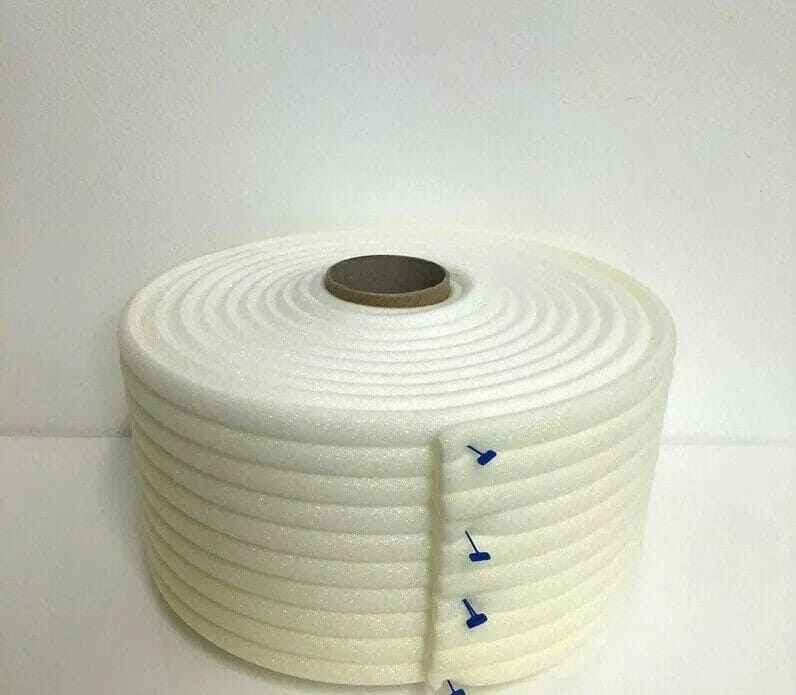 Large roll of white premium foam masking tape with blue tabs on plain white background